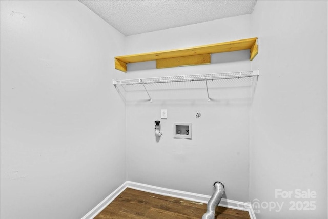 washroom featuring electric dryer hookup, hookup for a washing machine, a textured ceiling, and dark hardwood / wood-style floors