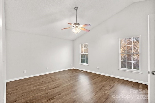 spare room with dark hardwood / wood-style flooring, high vaulted ceiling, and ceiling fan