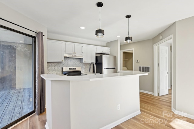 kitchen with stainless steel appliances, backsplash, white cabinetry, and decorative light fixtures