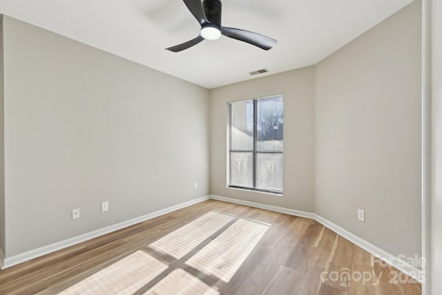 empty room featuring ceiling fan and light hardwood / wood-style flooring