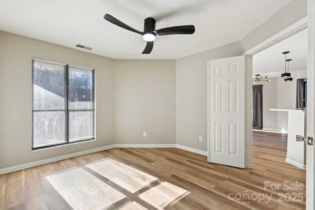 unfurnished room with ceiling fan and hardwood / wood-style flooring