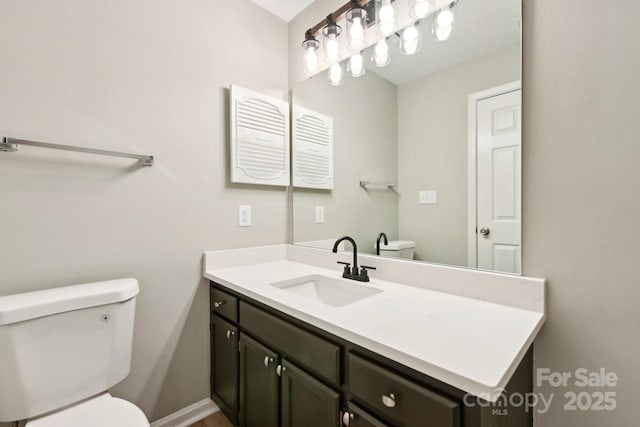 bathroom featuring toilet and vanity