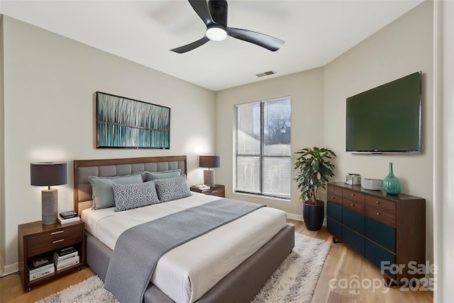 bedroom with ceiling fan and light hardwood / wood-style floors