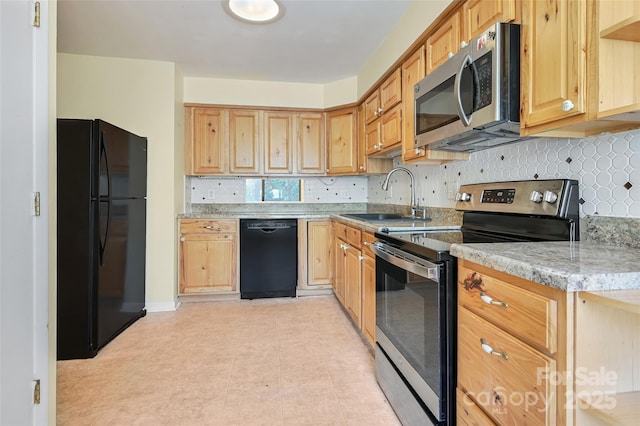 kitchen featuring sink, backsplash, black appliances, and light stone counters