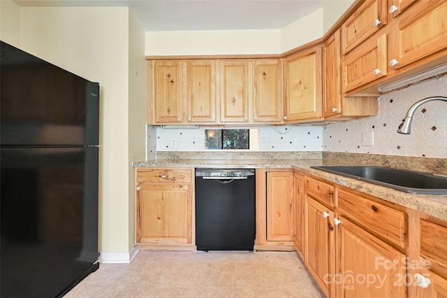 kitchen featuring black appliances, decorative backsplash, and sink