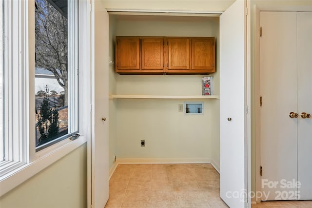 washroom with light tile patterned flooring, hookup for a washing machine, cabinets, and hookup for an electric dryer