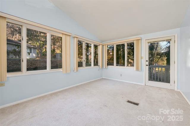 unfurnished sunroom featuring vaulted ceiling