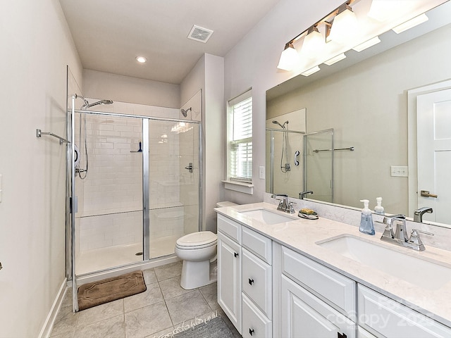 bathroom with vanity, a shower with door, and tile patterned flooring