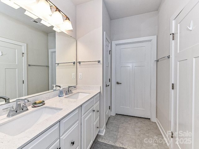 bathroom featuring tile patterned flooring and vanity