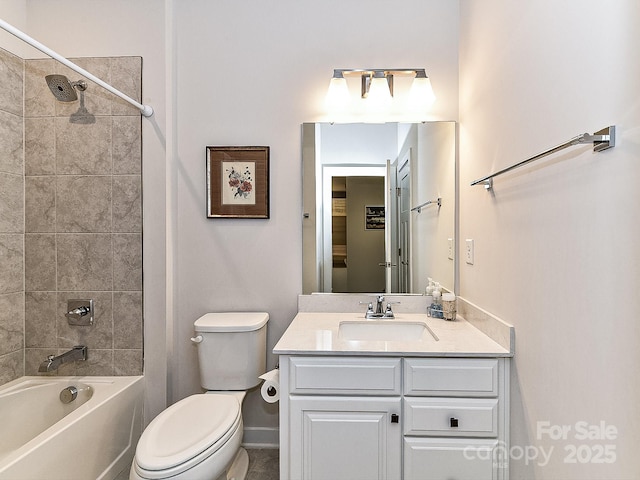 full bathroom featuring toilet, tiled shower / bath, and vanity