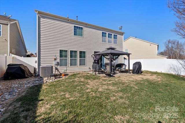 rear view of house featuring cooling unit, a patio area, a gazebo, and a lawn