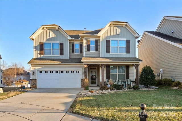 craftsman-style home with a garage, covered porch, and a front yard