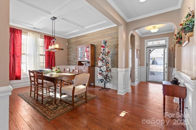 dining space with a wealth of natural light, wood-type flooring, ornamental molding, and coffered ceiling