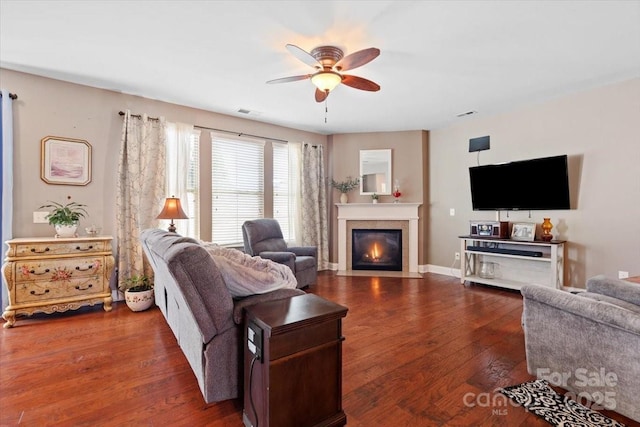 living room with ceiling fan and dark hardwood / wood-style flooring