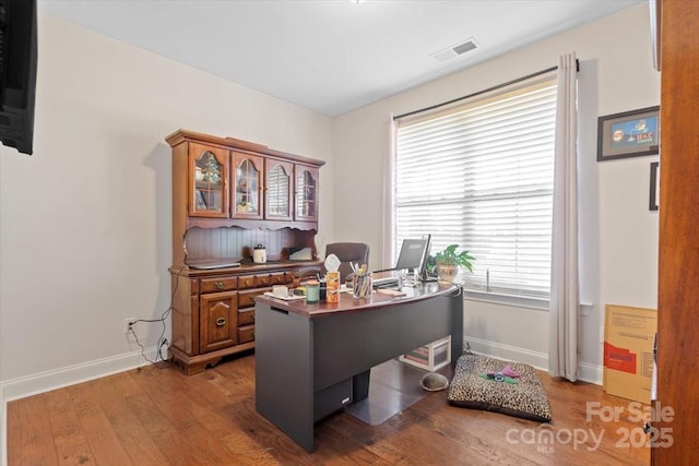 home office with dark wood-type flooring