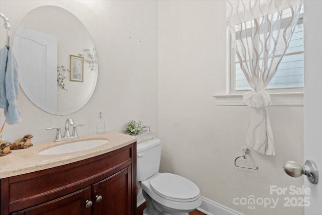 bathroom with toilet and vanity