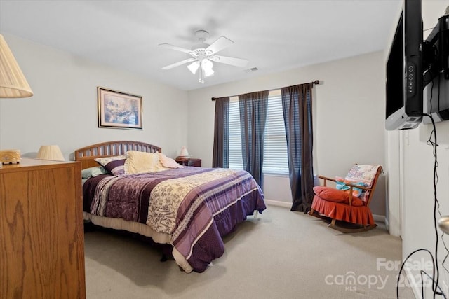 bedroom featuring ceiling fan and carpet