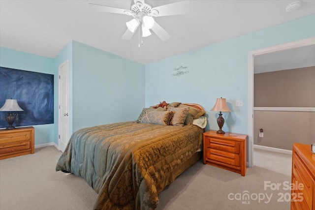 bedroom with ceiling fan and light carpet