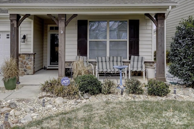 property entrance featuring a garage and a porch