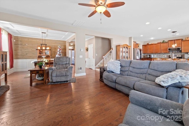 living room with dark hardwood / wood-style floors and ceiling fan