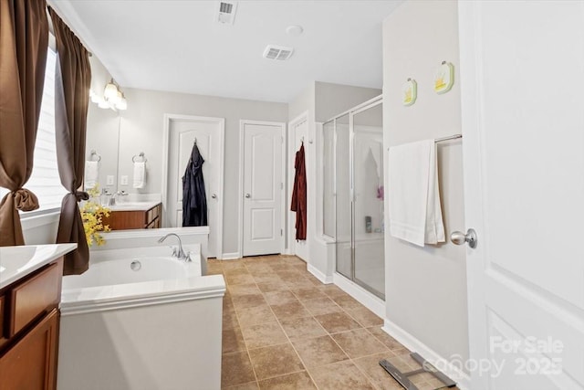 bathroom featuring vanity and shower with separate bathtub