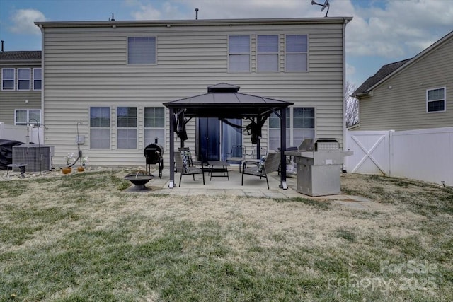 rear view of house with a gazebo, a yard, central air condition unit, and a patio area