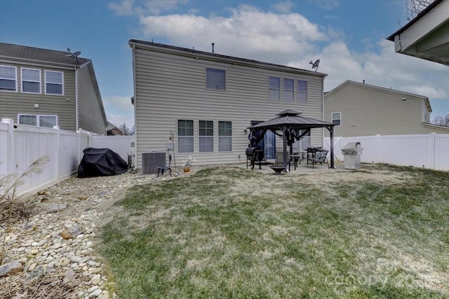 rear view of house featuring a gazebo, a patio area, a lawn, and central air condition unit