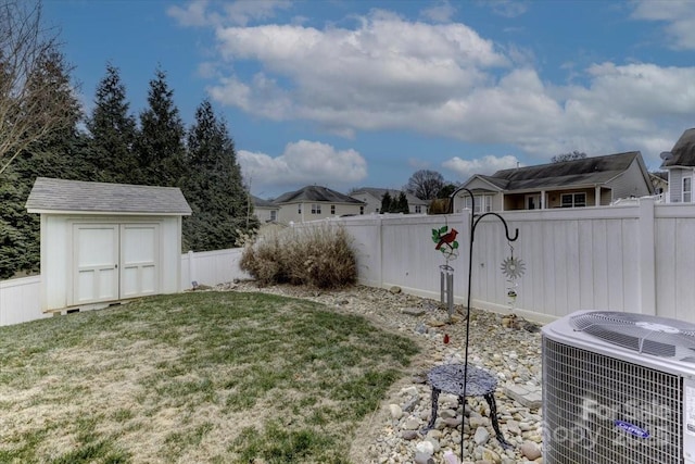 view of yard featuring central AC unit and a storage shed