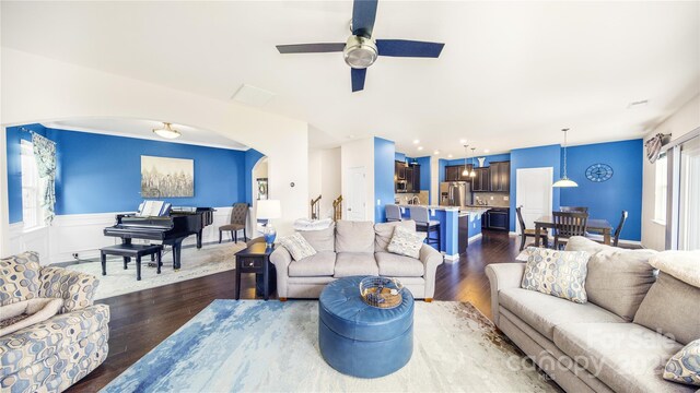 living room with ceiling fan and dark wood-type flooring