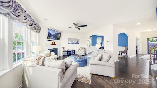 living room with ceiling fan and dark hardwood / wood-style floors