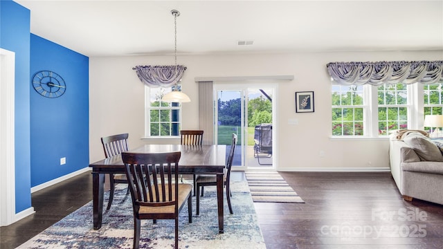 dining space featuring a chandelier and dark wood-type flooring