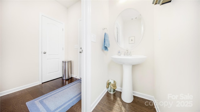 bathroom with hardwood / wood-style flooring