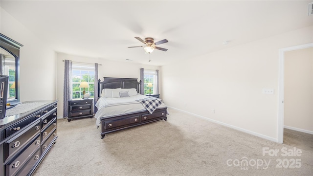 bedroom with ceiling fan and light carpet