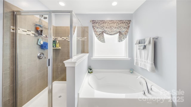 bathroom with shower with separate bathtub