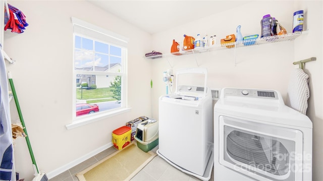 laundry room featuring light tile patterned floors and washer and dryer