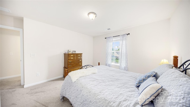 bedroom featuring light colored carpet