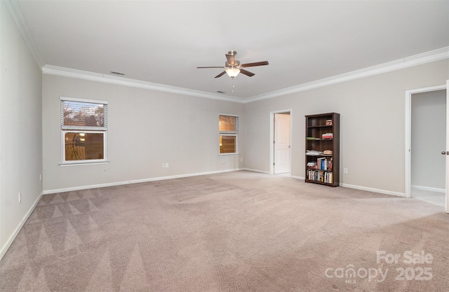 empty room featuring crown molding, ceiling fan, and light colored carpet