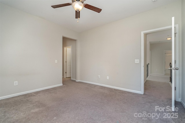 carpeted spare room with ceiling fan