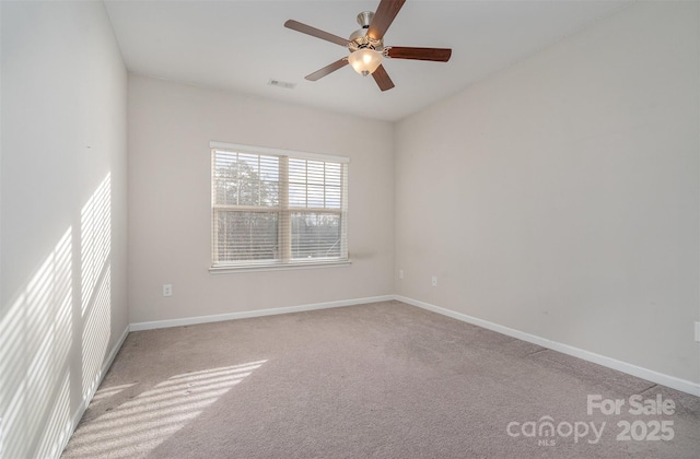 empty room featuring ceiling fan and light colored carpet