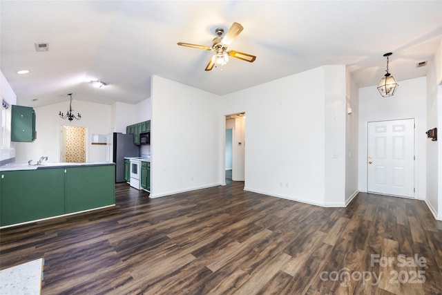 unfurnished living room featuring sink, ceiling fan with notable chandelier, dark wood-type flooring, and lofted ceiling