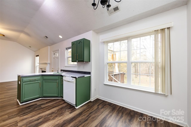 kitchen featuring green cabinetry, vaulted ceiling, a textured ceiling, and dishwasher