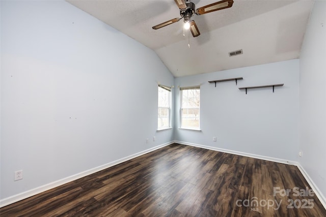 unfurnished room featuring ceiling fan, a textured ceiling, lofted ceiling, and dark hardwood / wood-style flooring