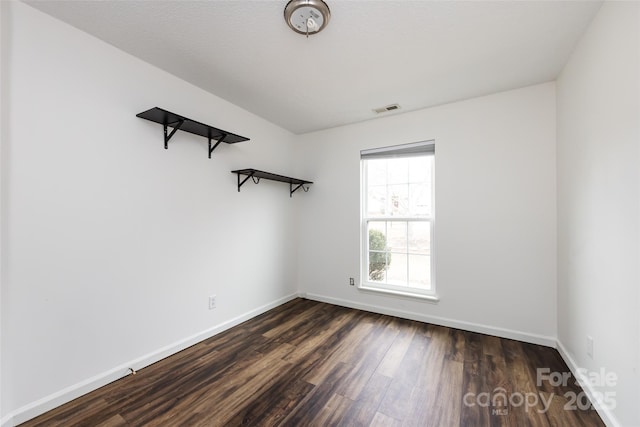 empty room featuring dark hardwood / wood-style flooring