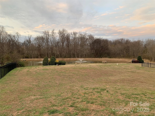 yard at dusk featuring a rural view