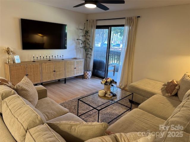 living room featuring ceiling fan and light wood-type flooring