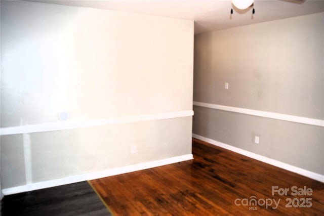 unfurnished room featuring ceiling fan and dark hardwood / wood-style floors