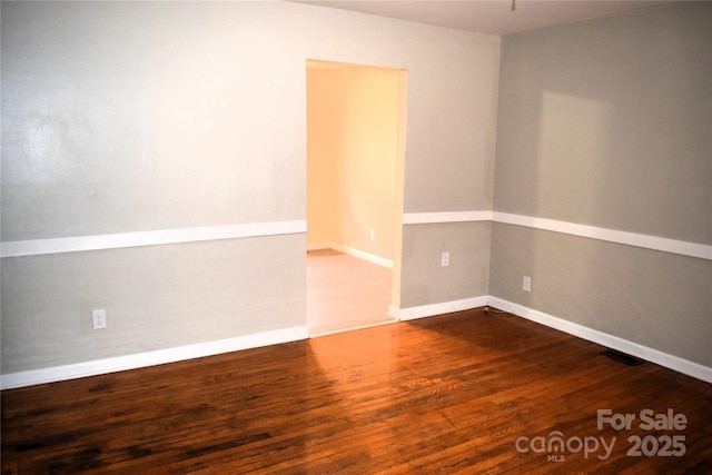 empty room with hardwood / wood-style floors