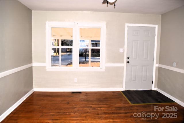 foyer entrance with dark hardwood / wood-style floors