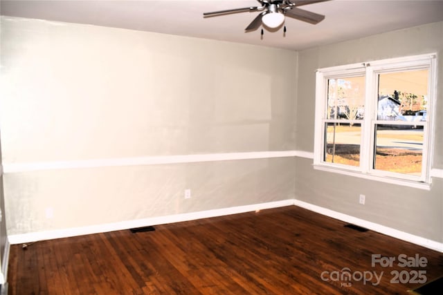 spare room featuring a wealth of natural light, ceiling fan, and wood-type flooring