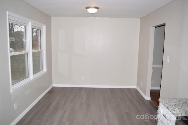 empty room with hardwood / wood-style floors